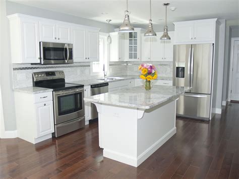 kitchen with white cabinets and stainless steel appliances|white countertops for kitchen cabinets.